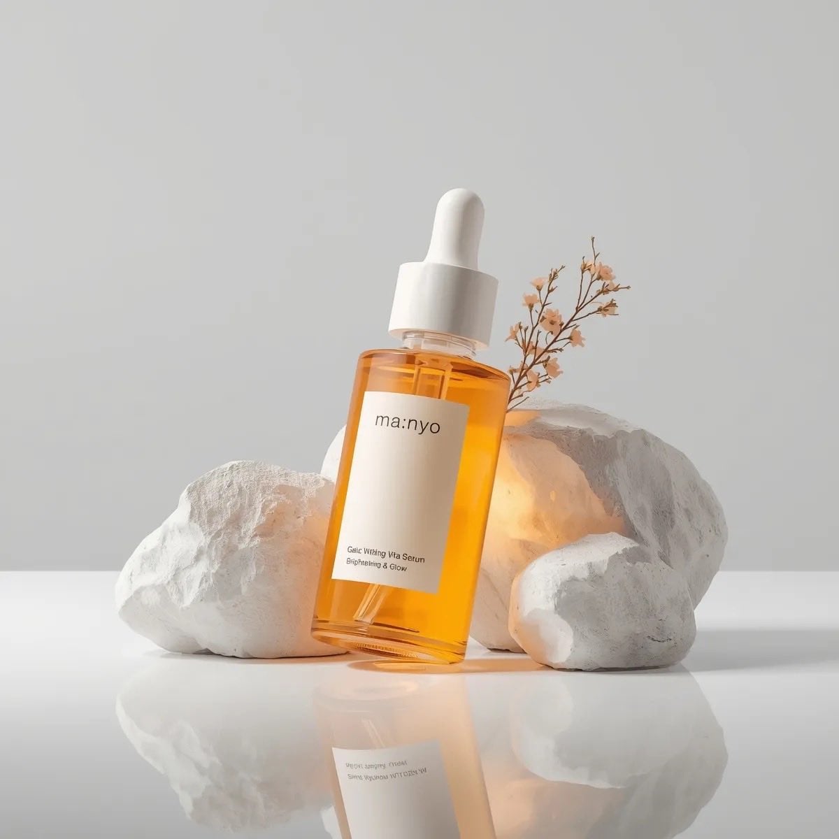 Minimalist studio product photography of an amber glass dropper serum bottle wit