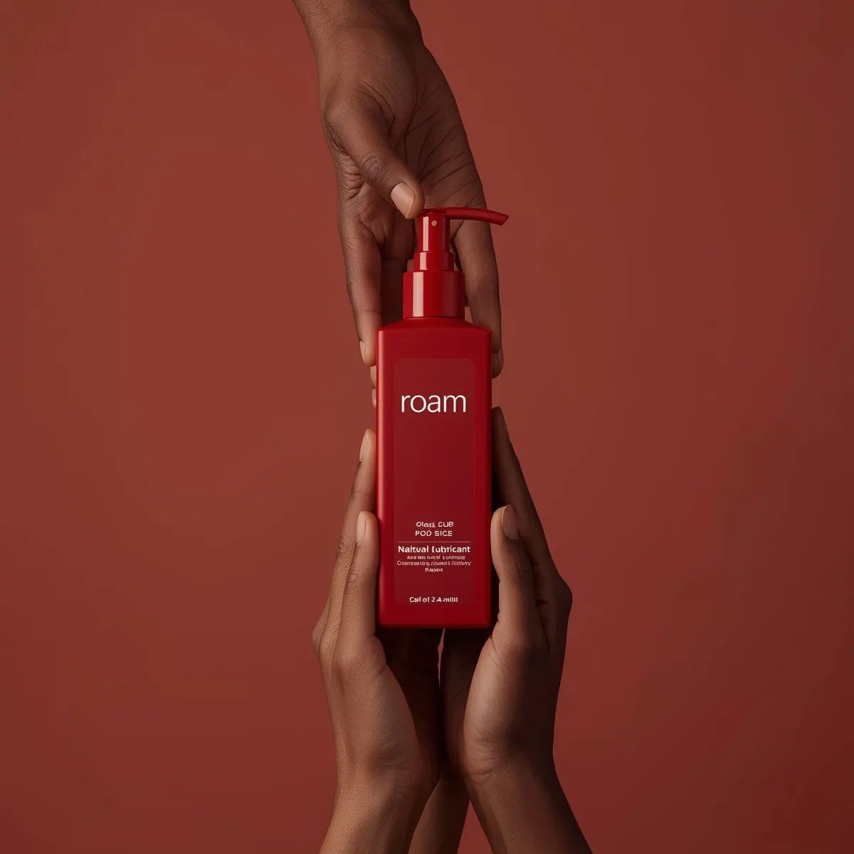 Minimalist product photography of a matte red pump bottle labeled ‘ROAM lubrican