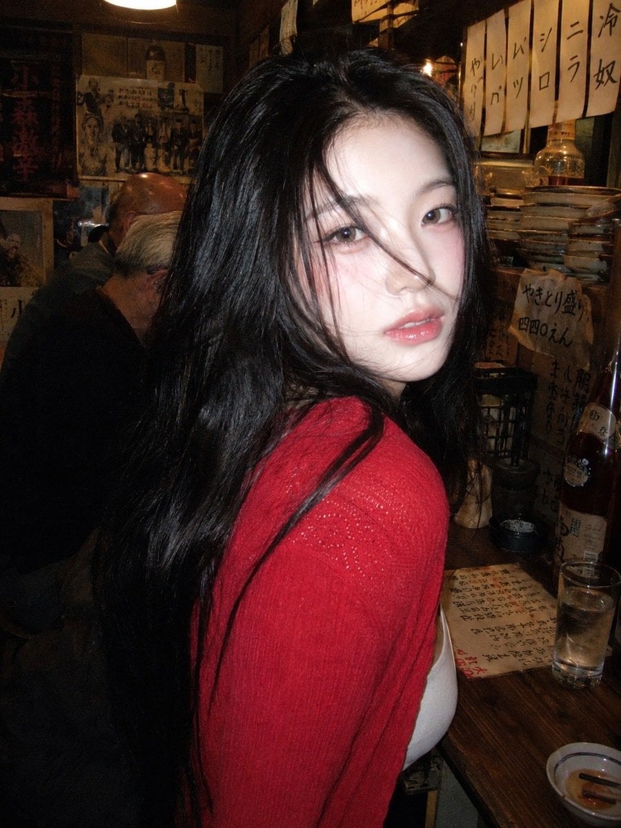A 90s disposable-camera style flash snapshot taken inside a small, bustling Japa