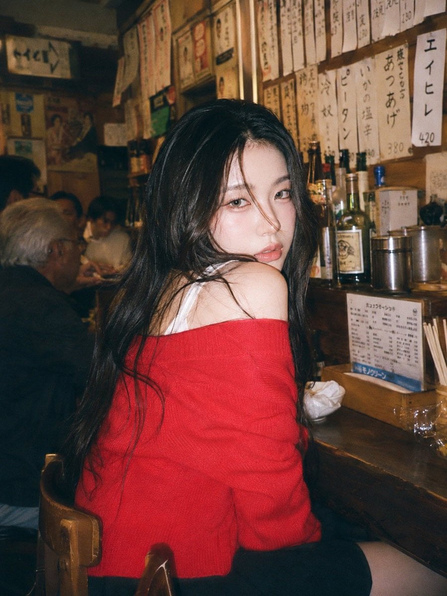 A 90s disposable-camera style flash snapshot taken inside a small, bustling Japa