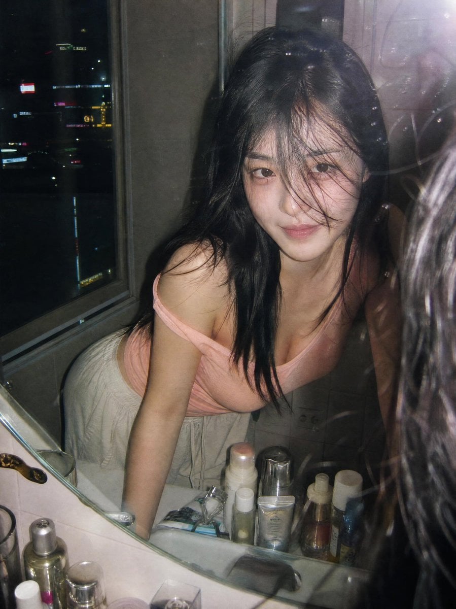 Ultra-realistic candid film photography portrait of a young woman leaning over a