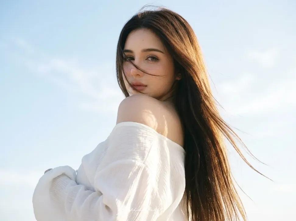 HAIRSTYLE: Ultra‑long, sleek dark brown hair with warm sun‑kissed highlights; so