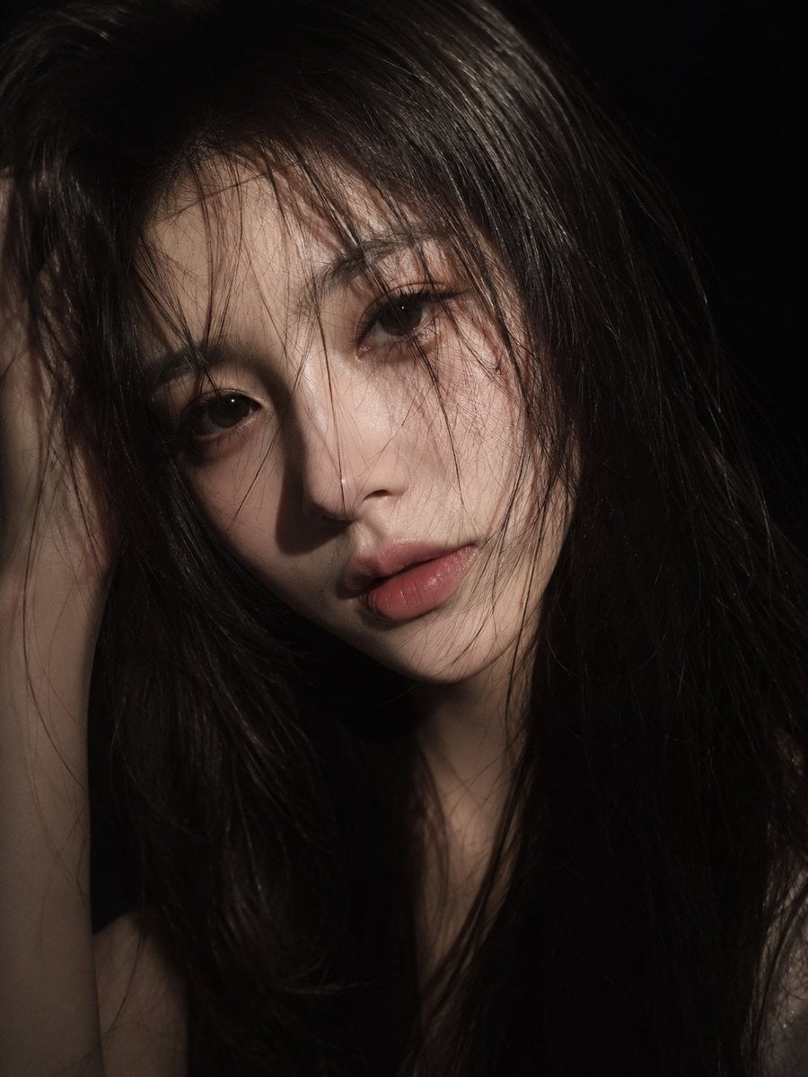 A cinematic close-up portrait of a young East Asian woman with long slightly mes