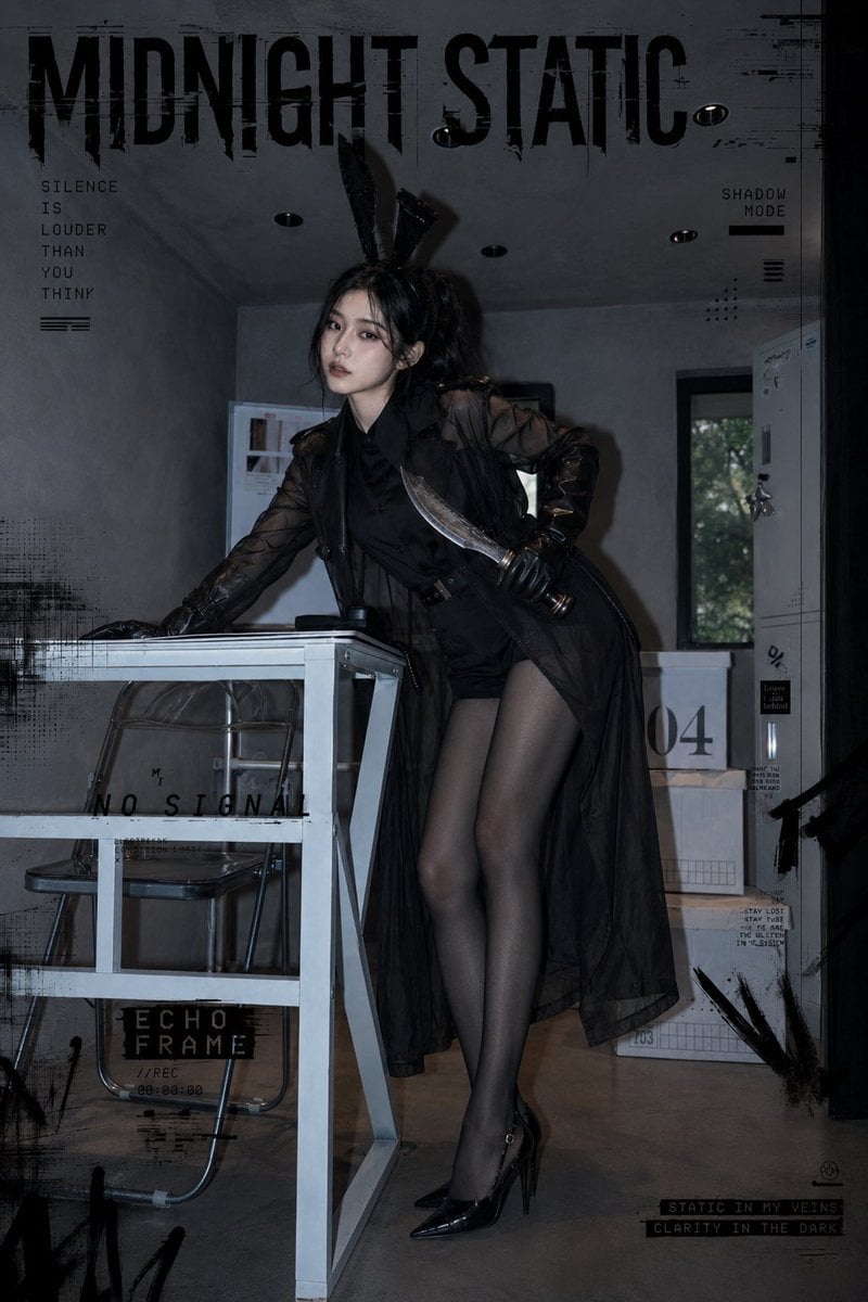 暗黑学院风时尚人像写真，一位成年亚洲女性模特，黑色高马尾，凌乱发丝，冷淡眼神，微微抬头看向镜头，神态安静又有压迫感。她穿着黑色衬衫、黑色短裤、黑色半透明风衣、黑