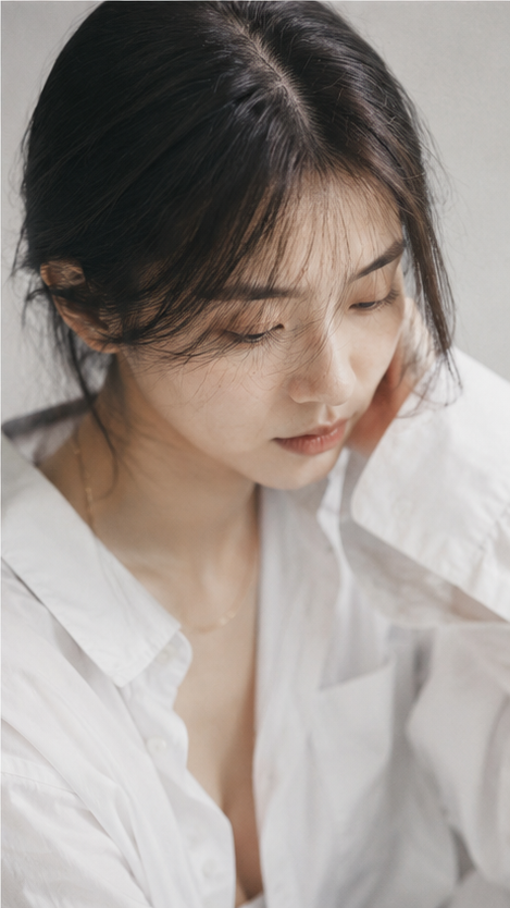 Portrait shot on 85mm f/1.8, editorial close-up of a Japanese woman in her mid-2