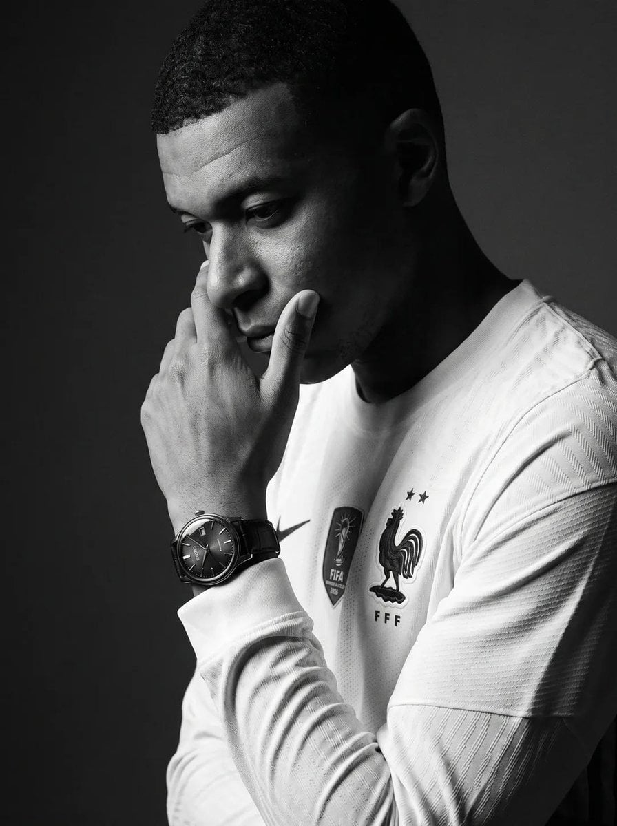 Create an ultra-realistic black-and-white editorial portrait of the uploaded per